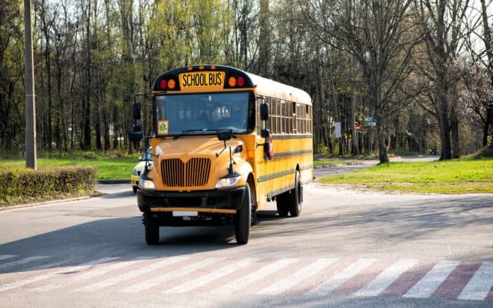 school bus assistant was arrested and terminated after reportedly spraying